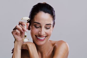 Beauty, derma roller and smile of woman in studio for...