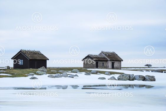 Old cabins in a barren winter landscape