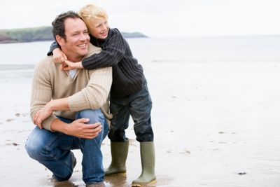 Father and son at beach smiling