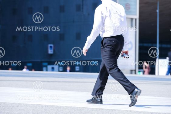 business man holding brief case and walking