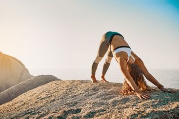 Woman, stretching and yoga fitness or seaside exercise,...