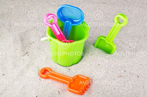 Child's bucket, spade and other toys on beach