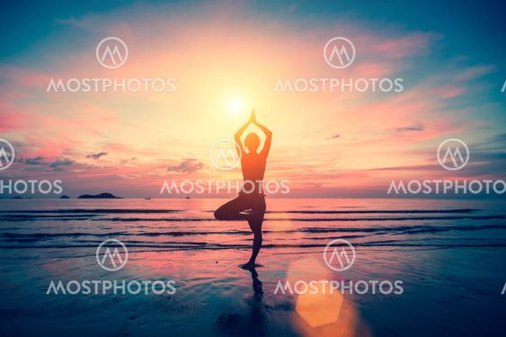 Silhouette yoga girl on the background of stunning sea and sunset. Fitness, meditation and healthy lifestyle.