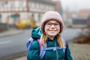 Cute little girl o the way to school. Healthy happy...