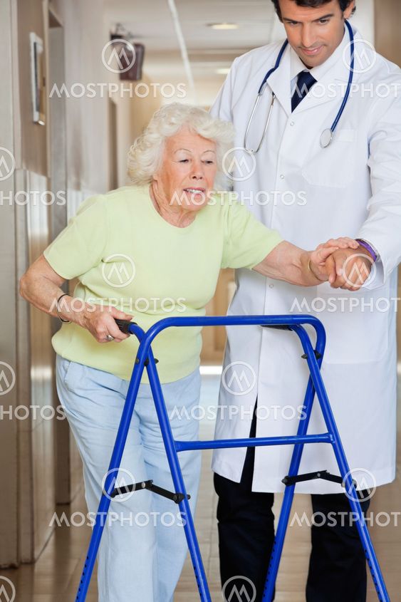 Doctor Showing Way To The Patient Using Walker