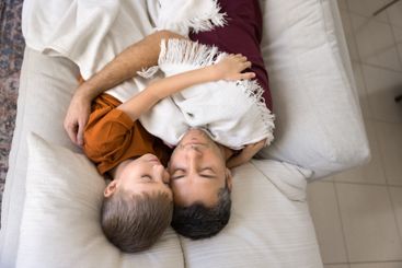 Above view of father and little son sleeping