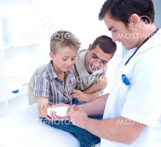 Doctor bandagins a patient's arm