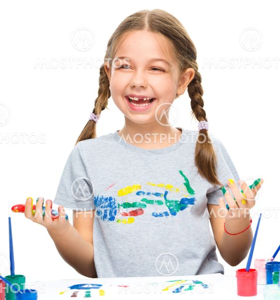 Portrait of a cute girl playing with paints