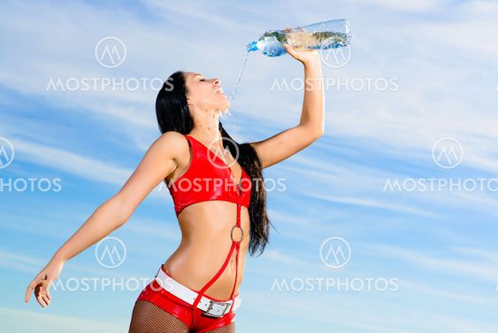 sport girl in red uniform with a bottle of water