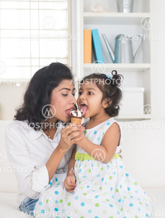 indian mother and child enjoying ice cream indoor