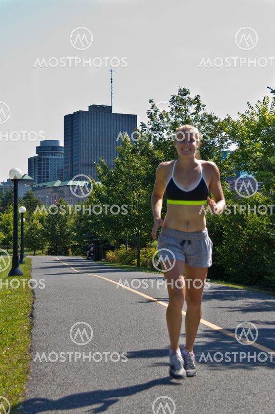 Woman running on a jogging trail in the city