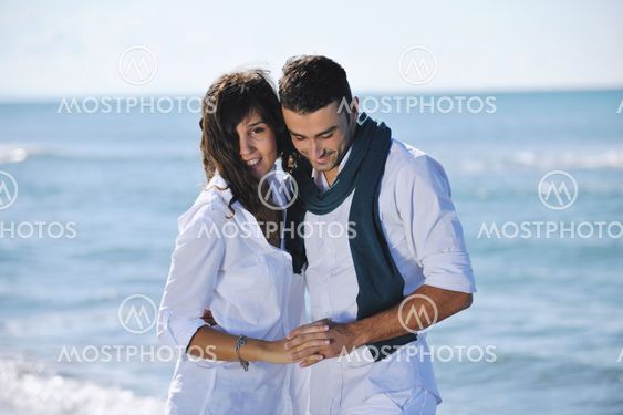 happy young couple have fun at beautiful beach