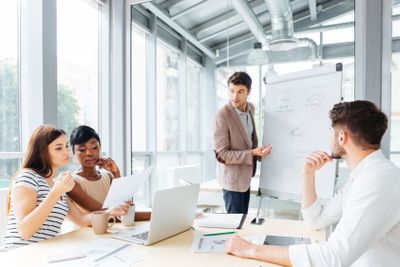 Businessman making presentation using flipchart in office