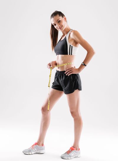 Full length portrait of a smiling happy sportswoman