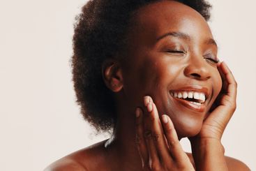 Beauty, happy and black woman with skincare in studio...