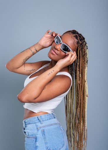 Beautiful brunette with braids in her hair, holding...