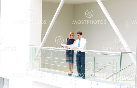 business man and business woman in the office to discuss reports