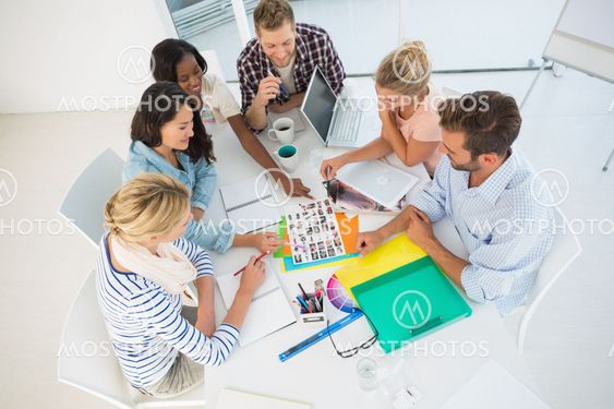 Young design team going over photography contact sheets together