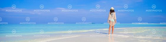 Young happy woman having fun on tropical white beach