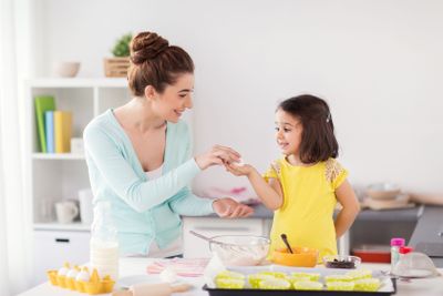happy mother and daughter baking at home