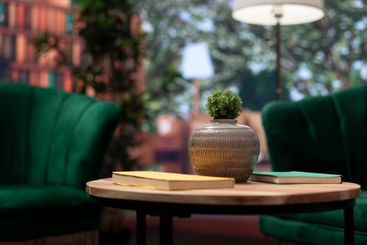 Modern empty home interior featuring green chairs and...