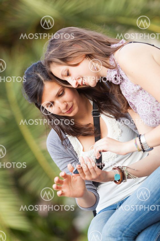 Two Beautiful Women Sending Messages with Mobile