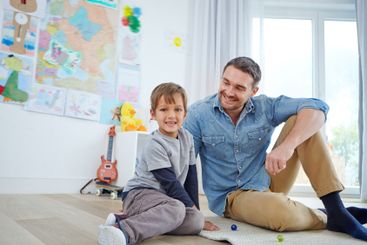 Father, playroom and happy kid relax in home for care,...
