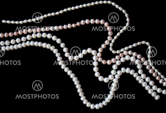 White and pink pearls on the black silk