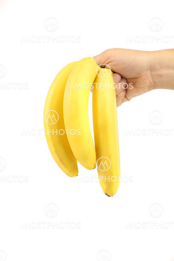 Hand holds bunch of bananas.