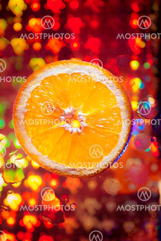 Orange with many water drops on the abstract background