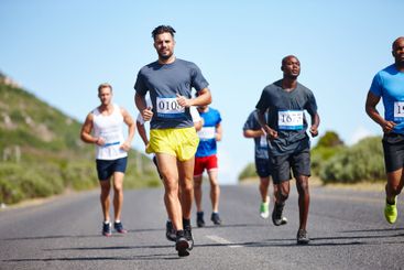 Sports, men and running marathon in road for race...
