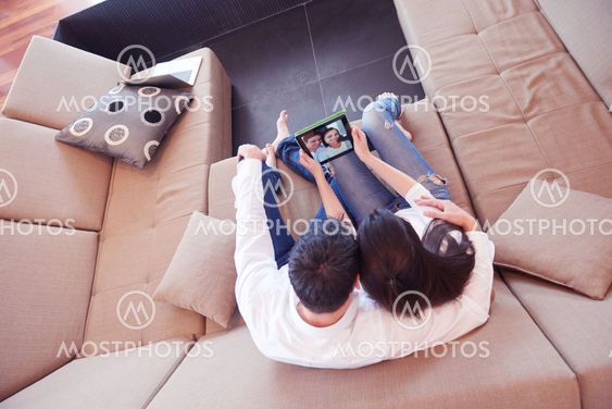 couple at modern home using tablet computer