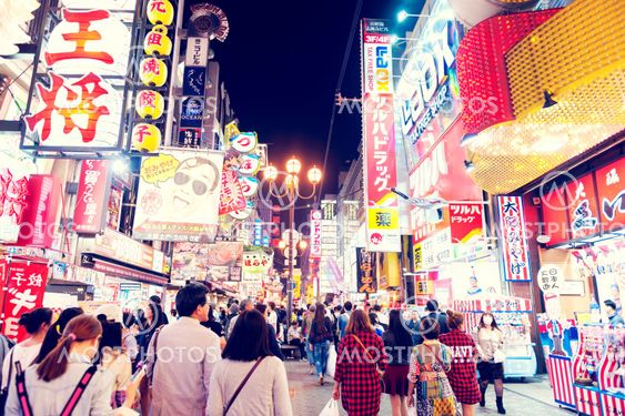 Osaka, Japan - April 2016: Tourist popular night shopping street in Osaka City at Dotonbori Namba area with illuminated neon signs and billboards alongside