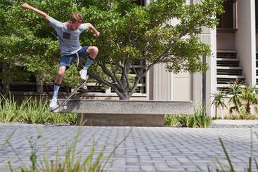 City, jump and man with skateboard, performance and...