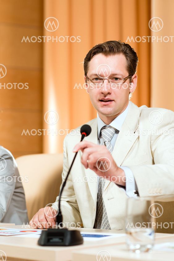 Portrait of a business man with microphone