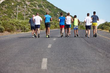 Group, fitness and back with running in road for...
