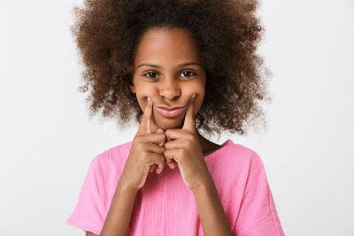 Upset moody little african girl wearing pink blouse