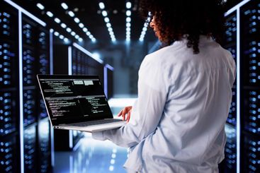 Cloud Computer Engineer Coding In Server Room In Data...