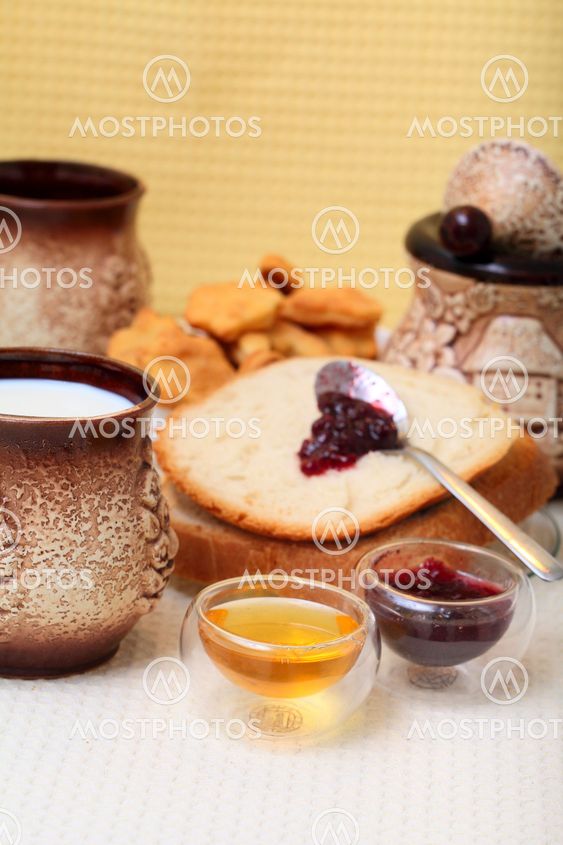 Homemade bread with redberries jam and honey