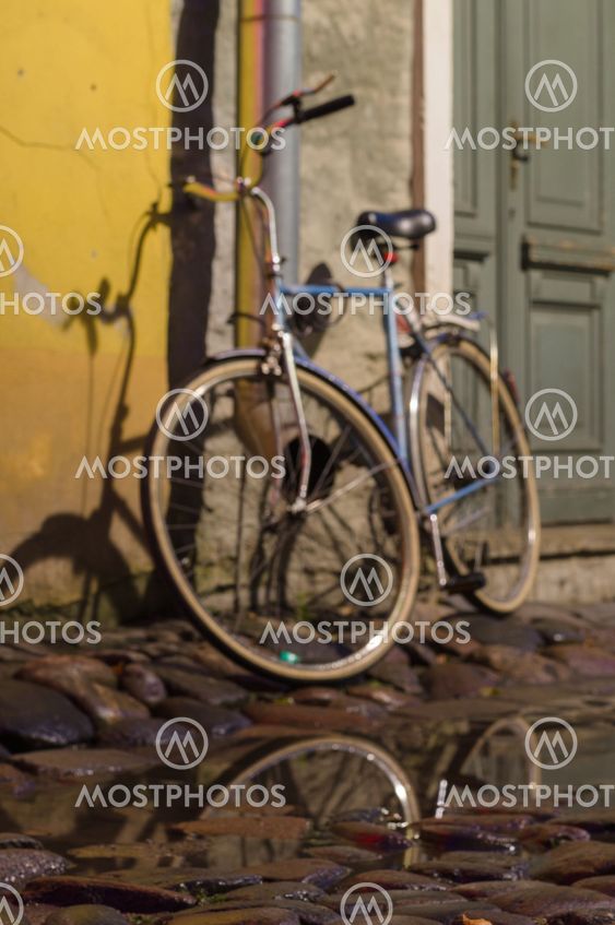 Vintage bike parked on cobbled street of old town
