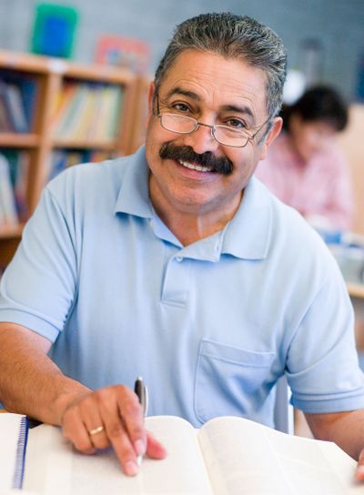 Mature male student studying in library