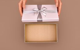 Woman opening empty pink gift box silver ribbon bow Mocha...