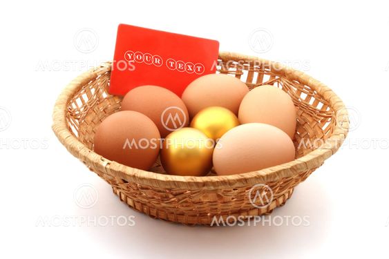 basket with usual chicken egg and golden egg on white background