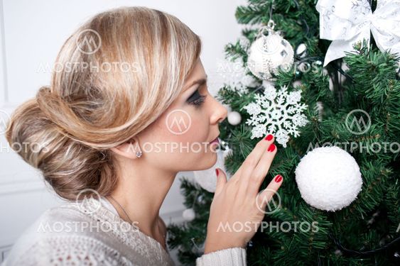 the beautiful girl near a New Year tree