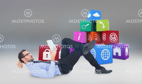 Composite image of businessman lying on the floor while reading a book