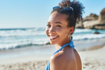 Beach, fashion and portrait of woman by ocean for...