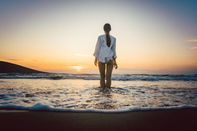 Woman at the beach in a moody sunset