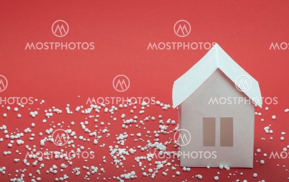 paper house in snow on red background