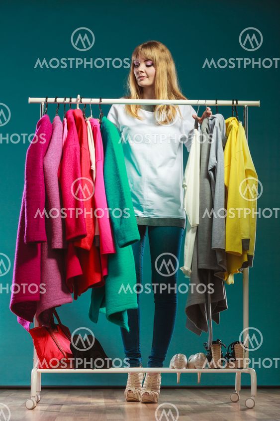 Woman choosing clothes to wear in mall or wardrobe