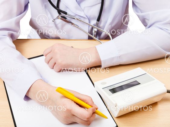 doctor measures blood pressure during appointment